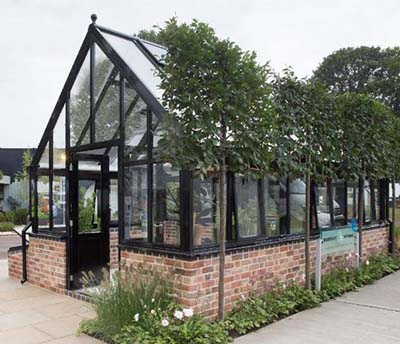 A stunning Hartley Botanic Opus Grand Botanic Glasshouse powder coated in black at the 2021 RHS Chelsea Flower Show