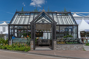 Calm and Wellbeing - Hartley  Botanic RHS Chelsea tradestand 2022 Victorian Lodge (with two additional single gable end doors) in manganese