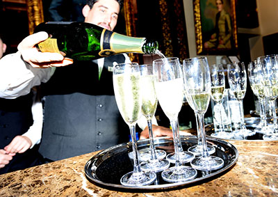 Gentleman pouring champagne for the Greenfingers Charity Dinner Sponsored by Vitax 