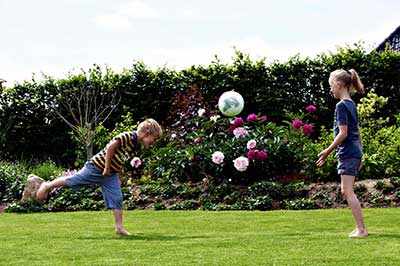 Lawn with children playing football