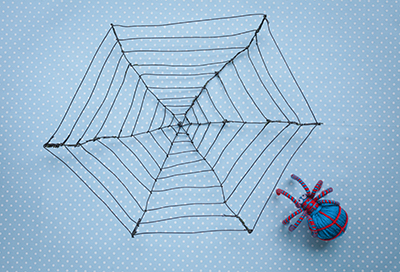 Knitted spider with web