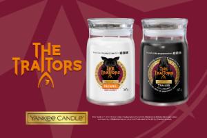The Traitors branded candles - a white one and a black one