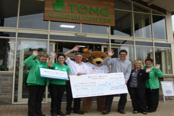 Martin House and Tong Garden Centre staff celebrating the donation