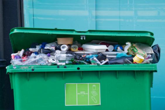 An overflowing commercial bin