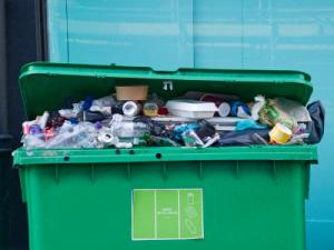 An overflowing commercial bin